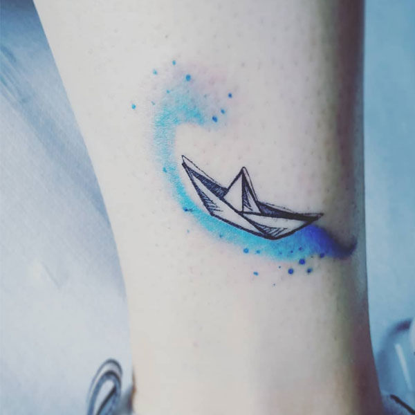  Tiny cute paper boat tattoo tint of blue color wave
