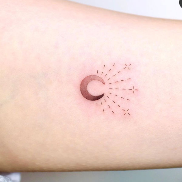 Small minimal moon shining tattoo
