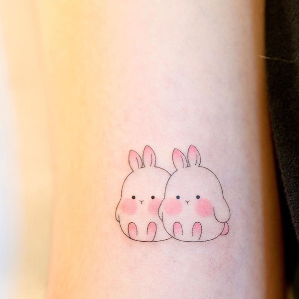 Two cute small creative bunnies tattoo