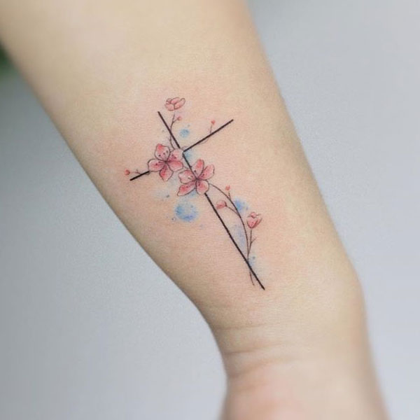 Beautiful designed small cross along with flower tattoo