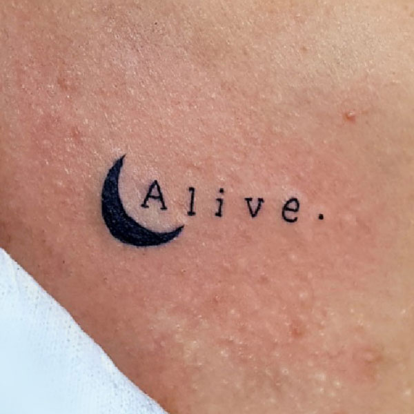 Minimal alive word tattoo with moon design