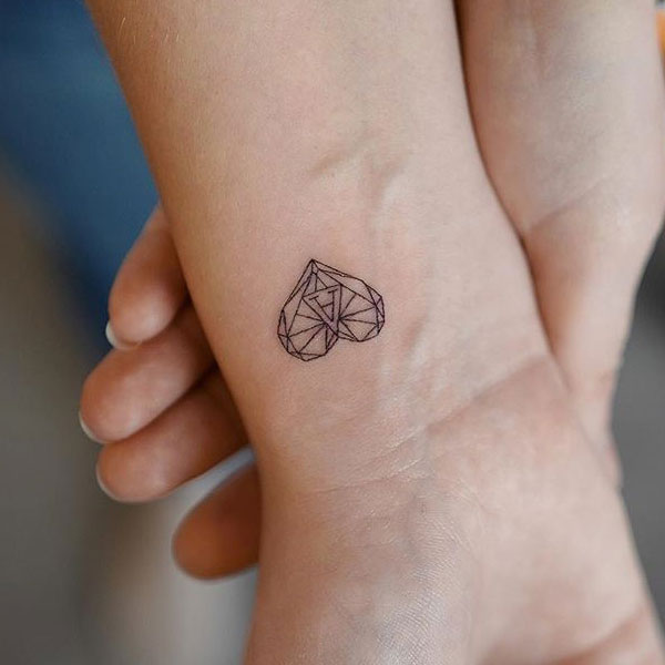 Mini geometric style heart name initial tattoo