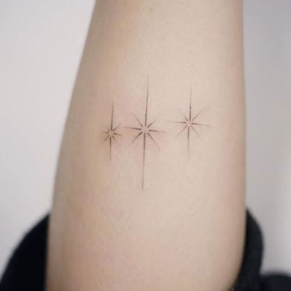 Sparkling shinning three-star tattoo