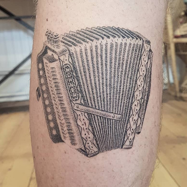 Black and grey button melodeon musical instrument tattoo
