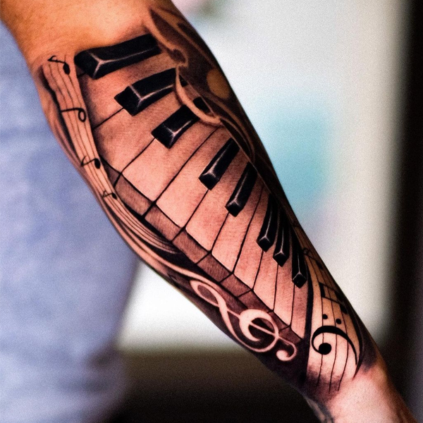 The elegant piano forearm sleeve tattoo