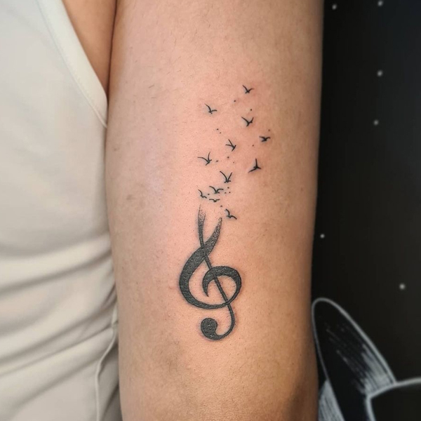 Elegant Musical notes with small birds tattoo