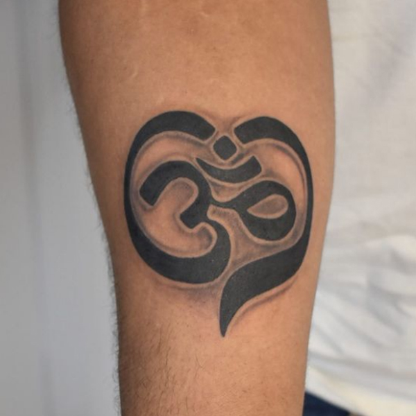Awesome black and bold Om heart style tattoo