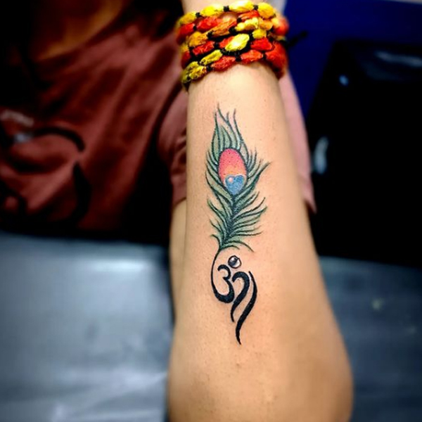 Stunning Om and peacock feather tattoo