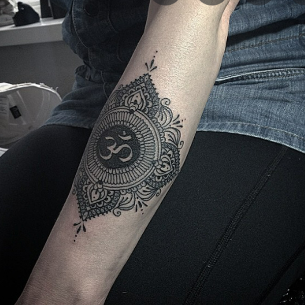 Fabulous ornamental om tattoo on the arm