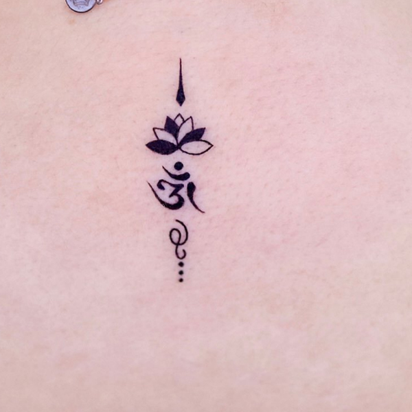 Trendy tiny lotus and om tattoo design