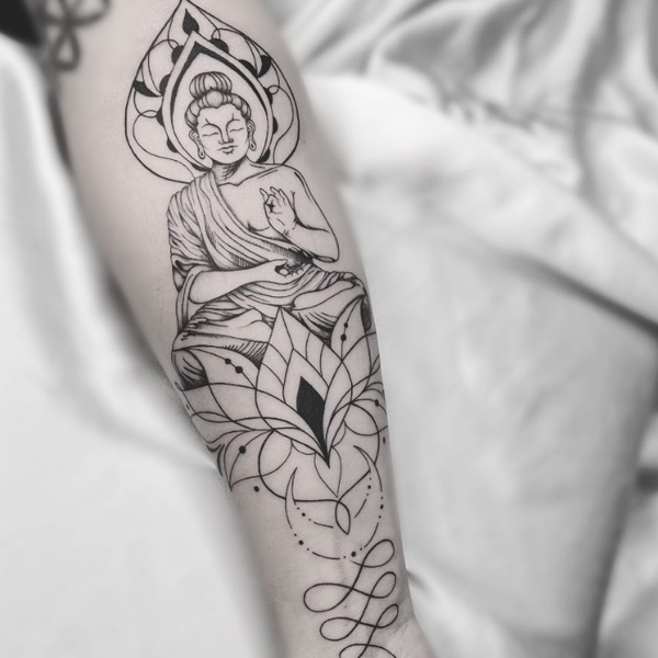 Pretty meditating form of buddha with lotus and unalome tattoo