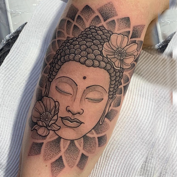 Awesome buddha face and dot work mandala tattoo