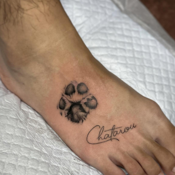  A cute dog paw print with his name tattoo design