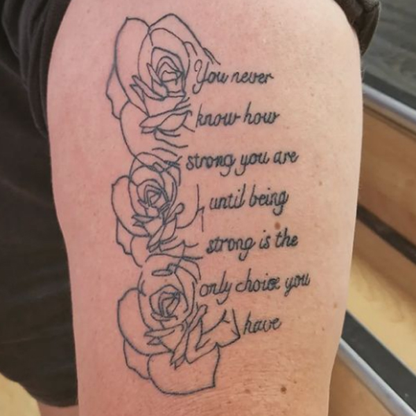 A fine line quote and roses tattoo