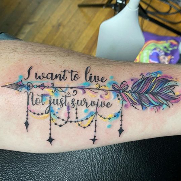  Elegant quote with arrow colorful tattoo design