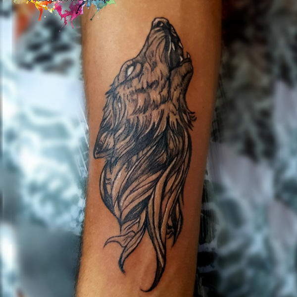 Amazing howling wolf black and grey tattoo