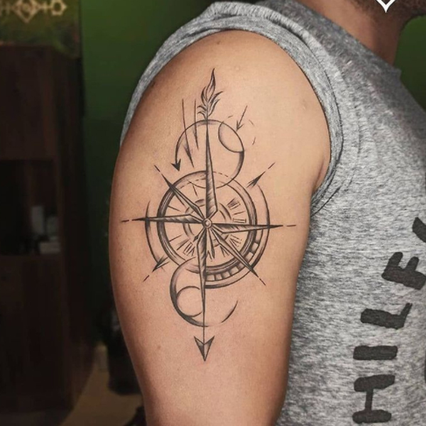 Classy compass fine line tattoo on the bicep