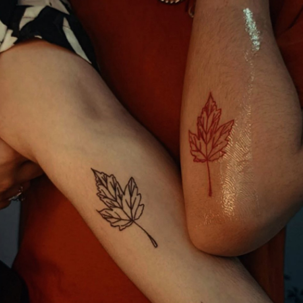 Black and colorful leaf tattoo for a couple