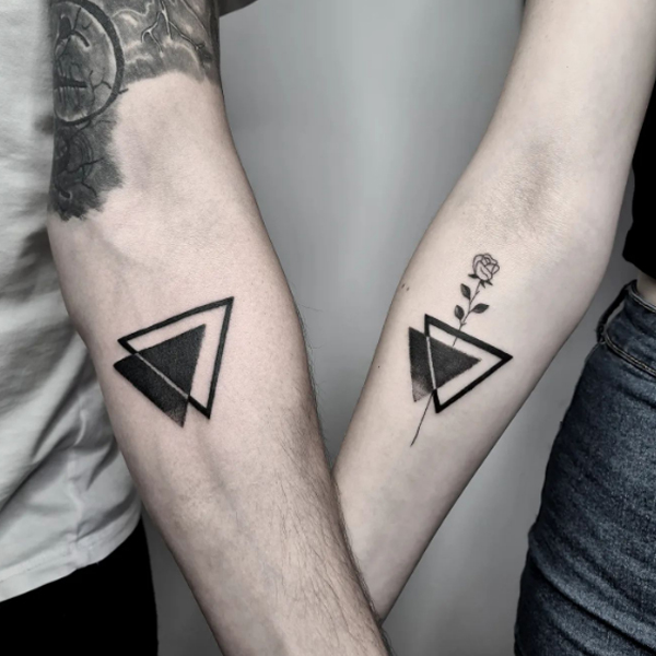 A bold geometrical triangle couple tattoo