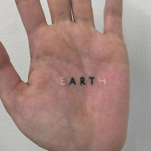 Creative small Earth script tattoo