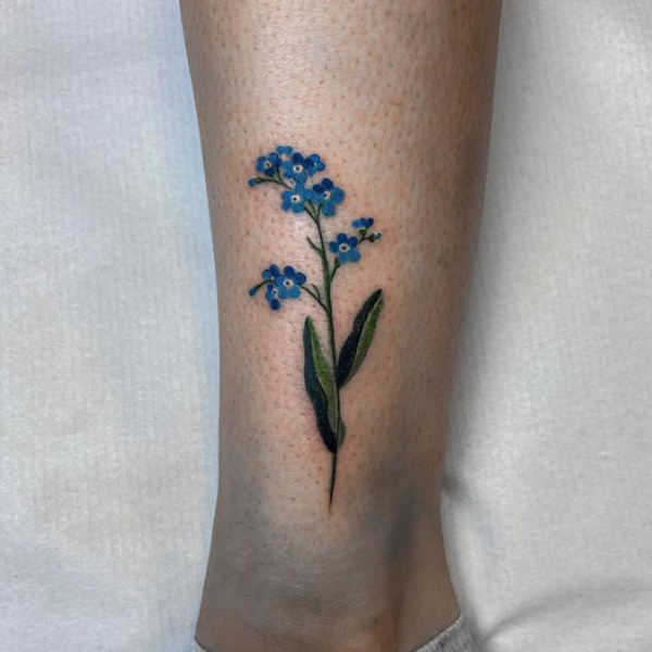 Stunning blue flower tattoo on leg