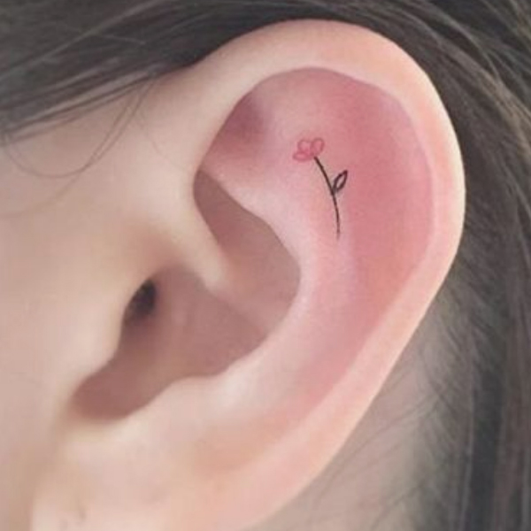 Tiny cute flower tattoo on the inner ear