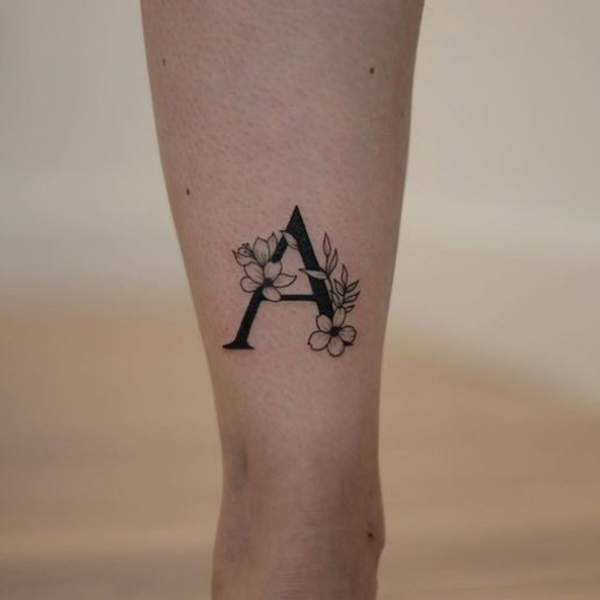 Awesome black and a bold flower and A-letter tattoo design
