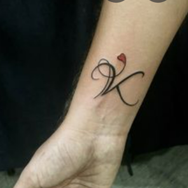 Pretty v-letter tattoo on the wrist