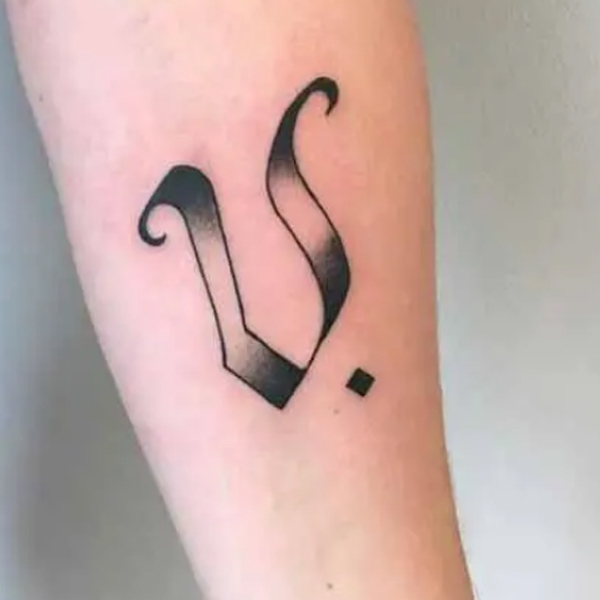 Stunning V-letter black and grey tattoo 