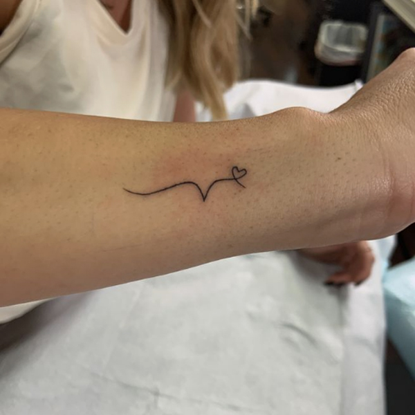Beautiful v-letter and small heart symbol minimal tattoo design