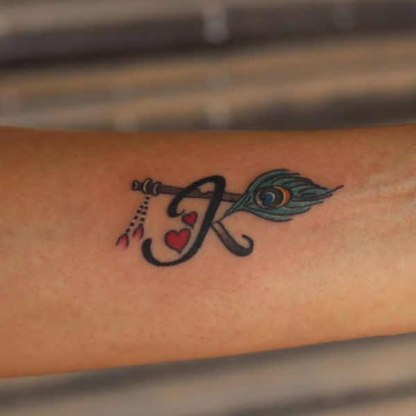 Beautiful K-letter, flute, and peacock feather, religious tattoo design