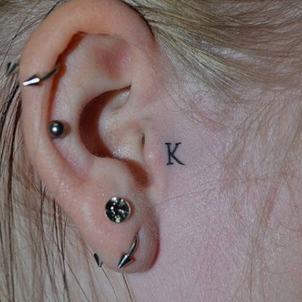 Tiny K-letter design ear tattoo design idea