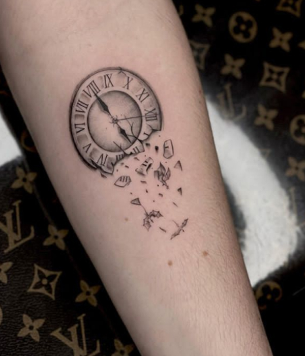 Beautiful broken piece clock tattoo over the hand