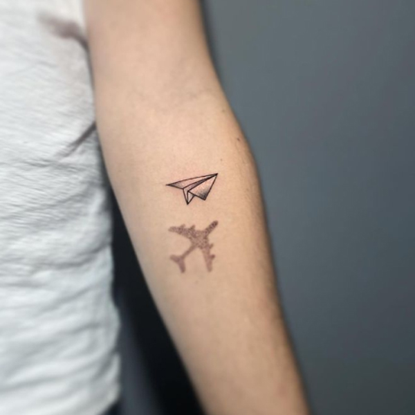 Tiny 3d paper plane tattoo on the hand