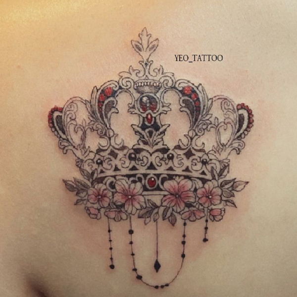 Awesome ornamental crown tattoo over the back