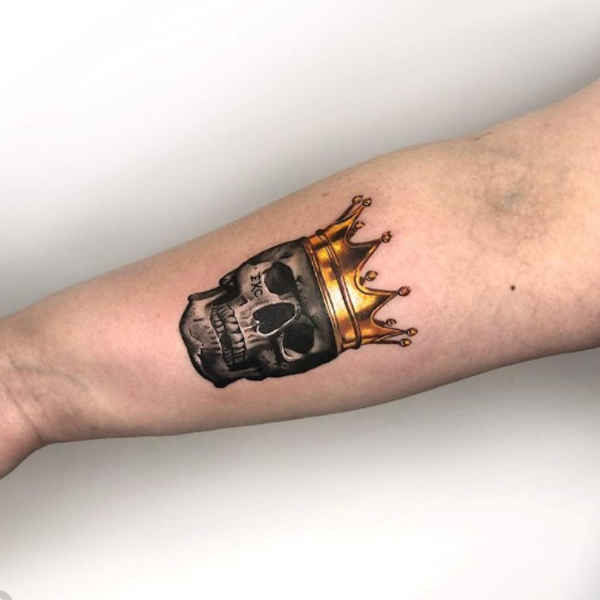 Awesome golden crown and skull tattoo on the hand