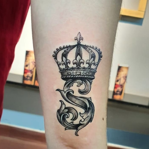 Stunning crown and alphabet tattoo