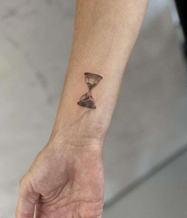 Minimal cute hourglass tattoo on the wrist