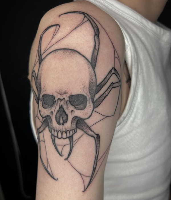 Attractive spider skull design tattoo over the bicep
