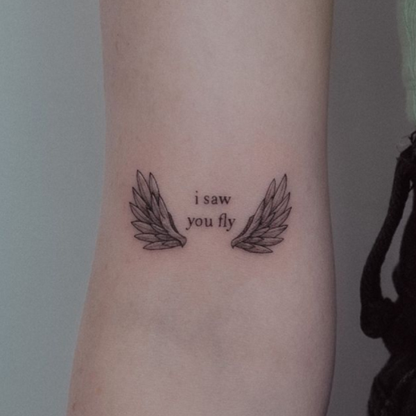 Cute small wings and quote tattoo design