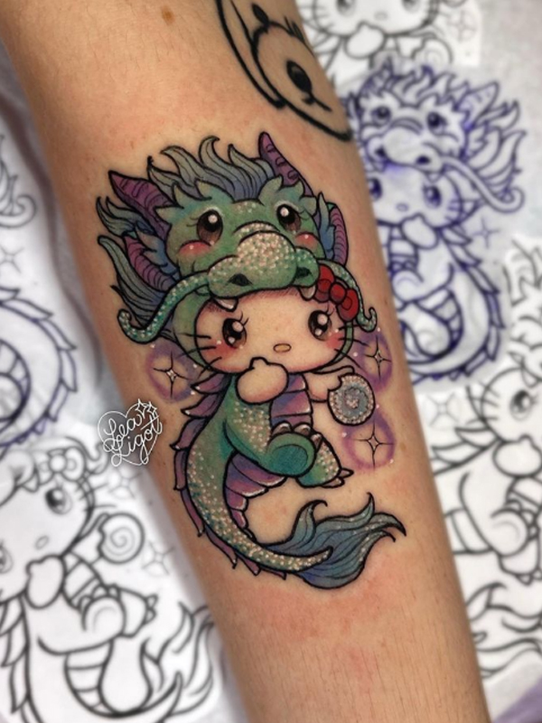  Cute little dragon and hello kitty cartoon tattoo design