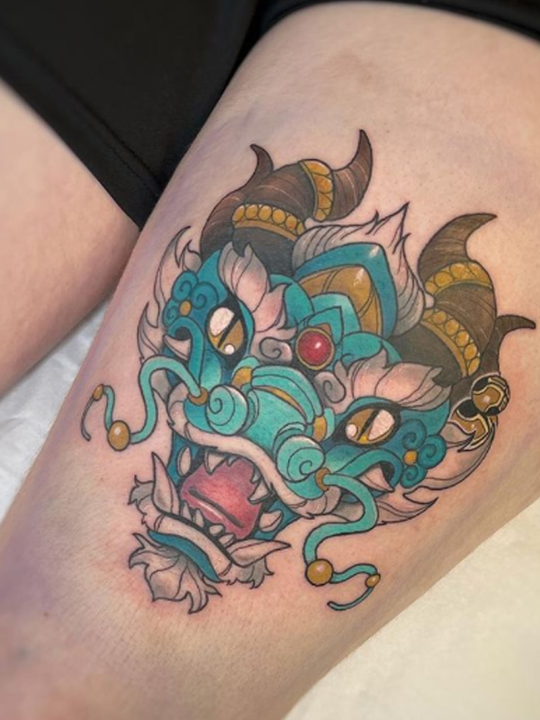 Awesome Dragon mask tattoo on the thigh