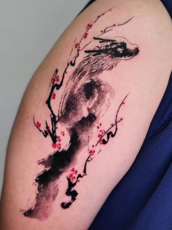 A beautiful black dragon with cherry blossom flower tattoo