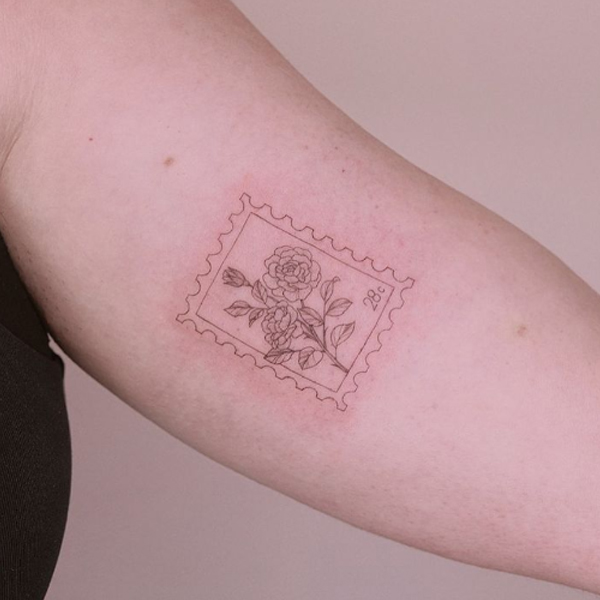 Fine line Rose postage stamp tattoo