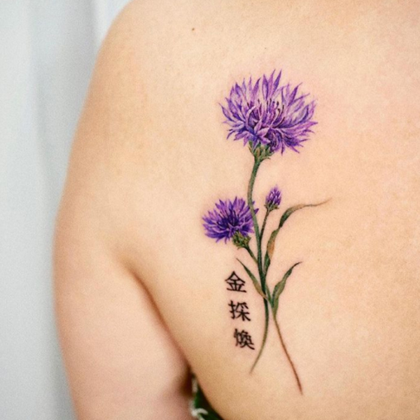 Gorgeous purple flower with lettering tattoo