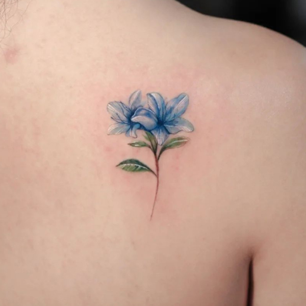 Charming blue lilies flower design tattoo