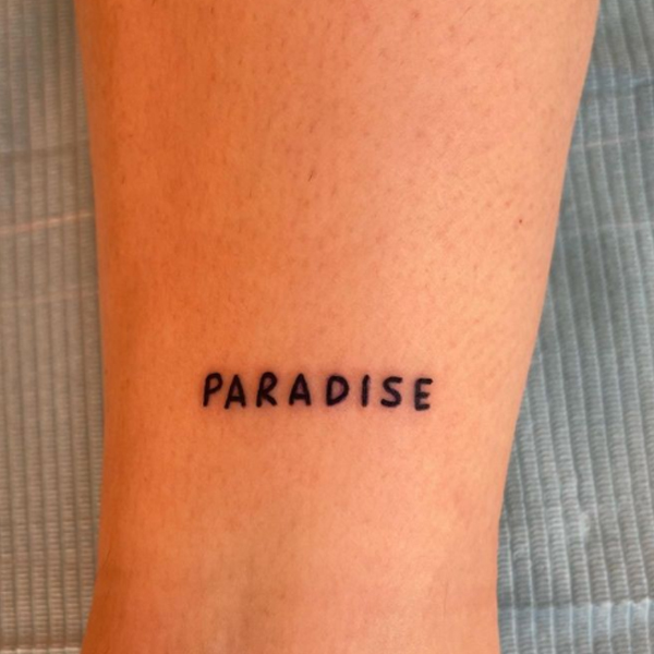  Black and bold paradise word tattoo 