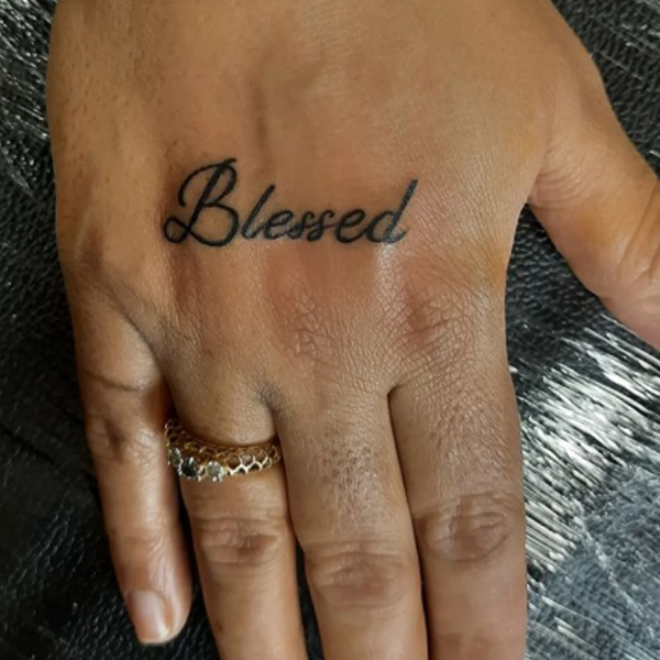Black calligraphy word blessed small tattoo for hand