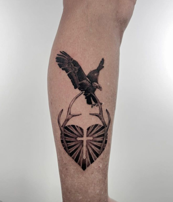 Black eagle, cross, and small heart tattoo design