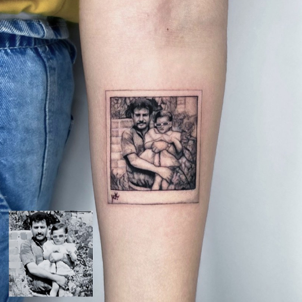 A cute daughter and father photo portrait tattoo on the arm